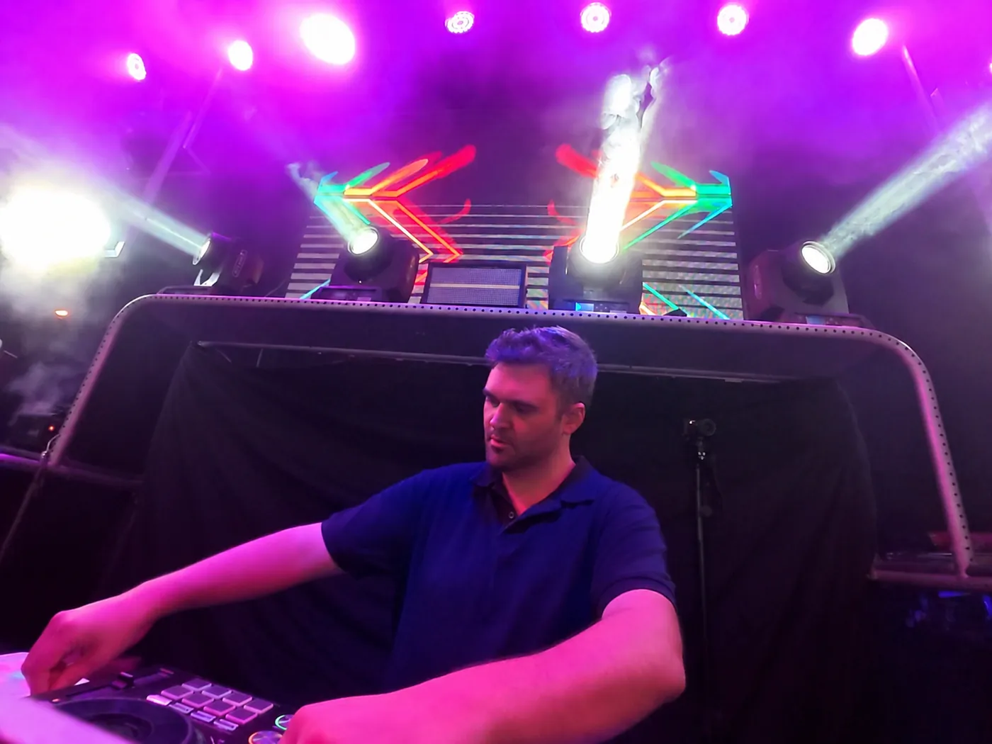 IWARO mixing beneath neon lights